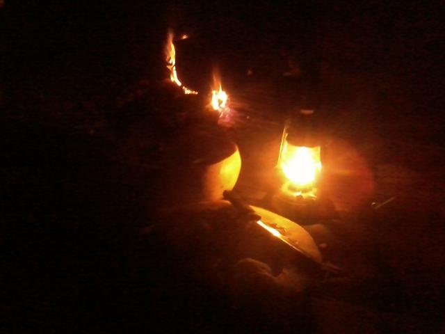 working in the light of an oil lantern